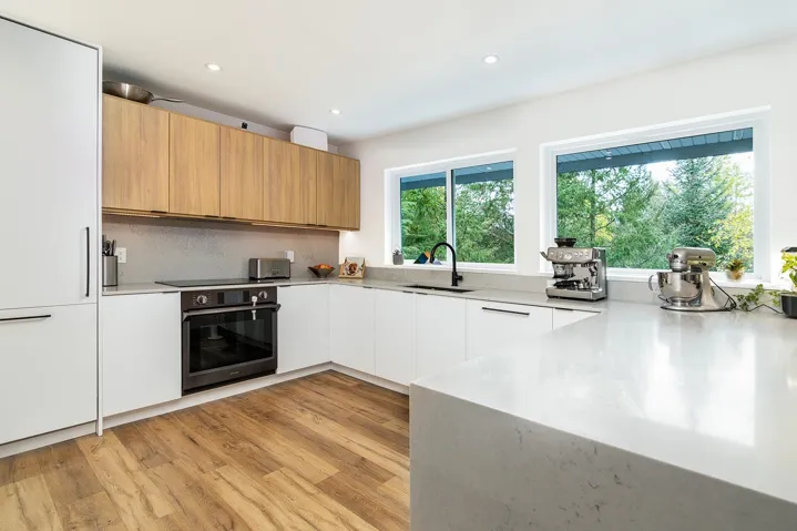 Kitchen featuring modern cabinets, oven, white cabinets, recessed lighting, and light wood-style floors