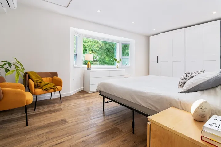Bedroom featuring light wood finished floors, recessed lighting, and a wall mounted air conditioner