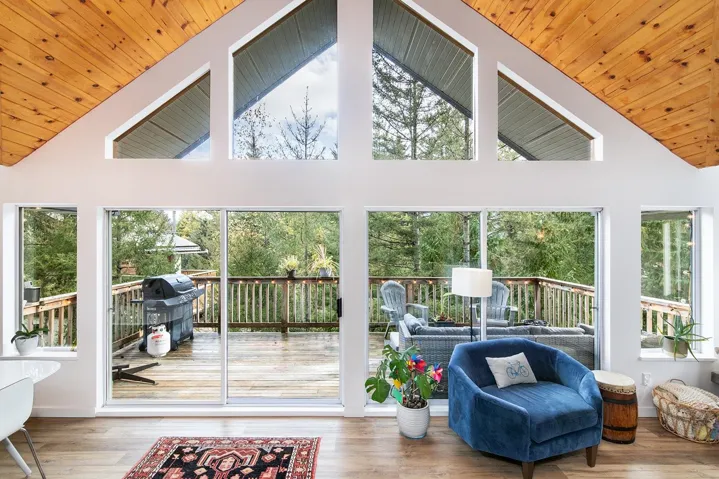 Sunroom with wood finished floors, high vaulted ceiling, and wooden ceiling
