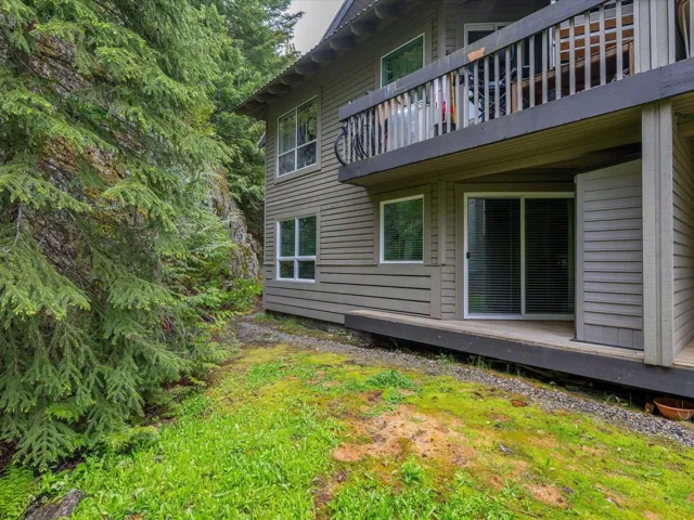 View of home's exterior with a balcony and a lawn