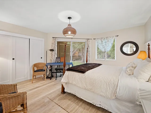 Bedroom featuring light wood finished floors and a closet