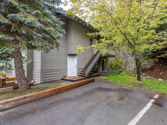 View of home's exterior featuring stairs, a patio, and stucco siding