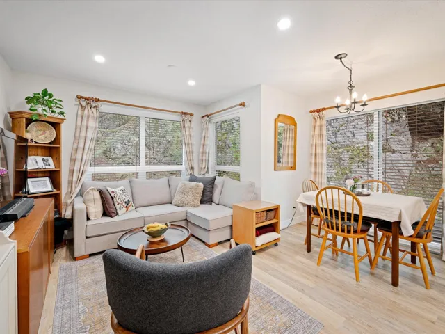 Living area with a chandelier, light wood-style floors, recessed lighting, and baseboards