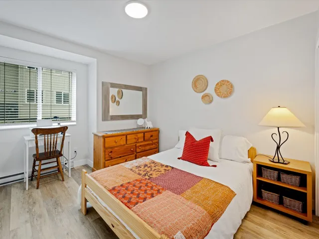 Bedroom featuring wood finished floors and baseboards
