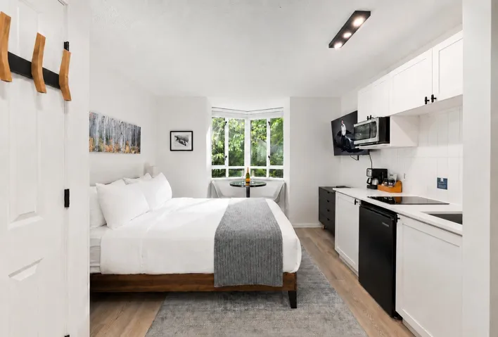 Studio space featuring wood-finish flooring and a corner window