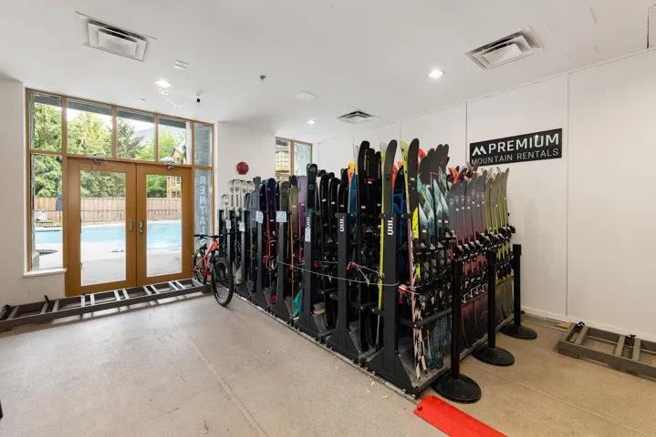 Spacious commercial interior featuring large double glass doors with transom windows, recessed lighting, and white walls
