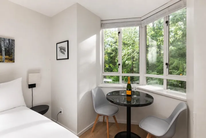 Bright corner with expansive bay windows featuring white frames