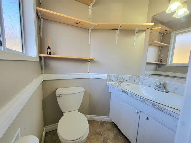 Half bathroom featuring toilet and vanity