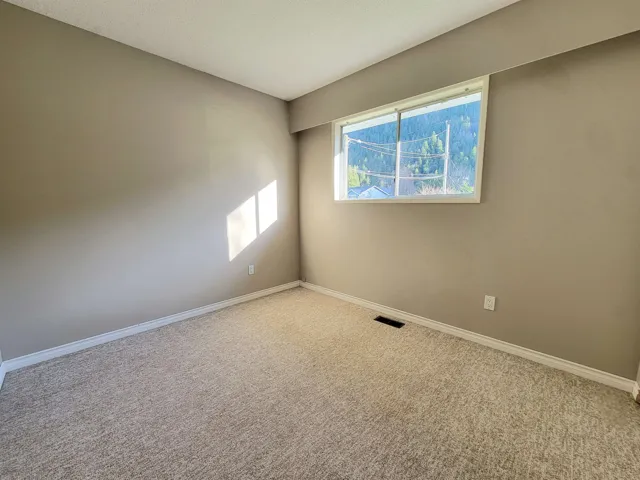 Carpeted spare room with baseboards