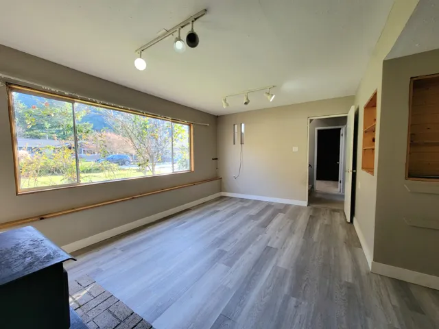Unfurnished room featuring rail lighting and light wood finished floors