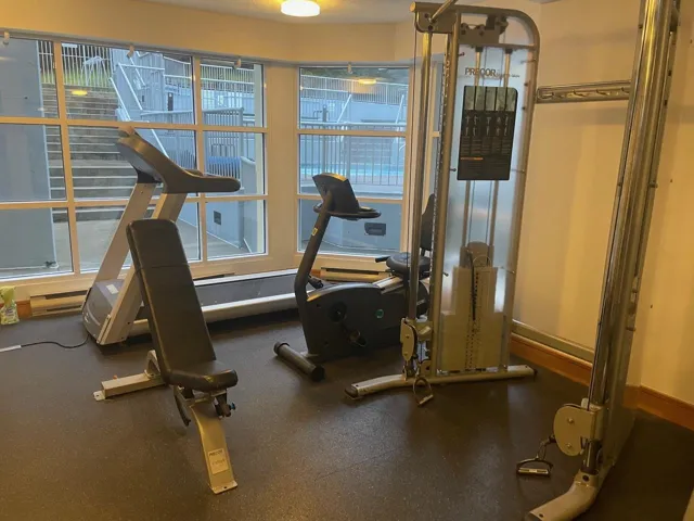 Exercise room featuring rubber floors and a baseboard heating unit