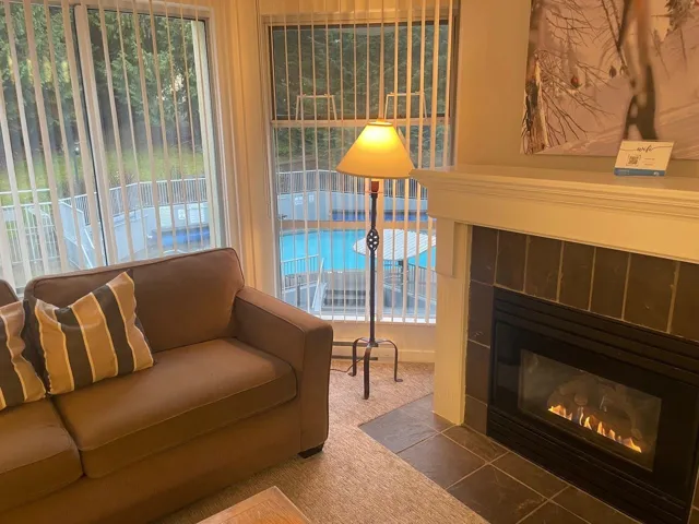 Carpeted living room with a fireplace with flush hearth