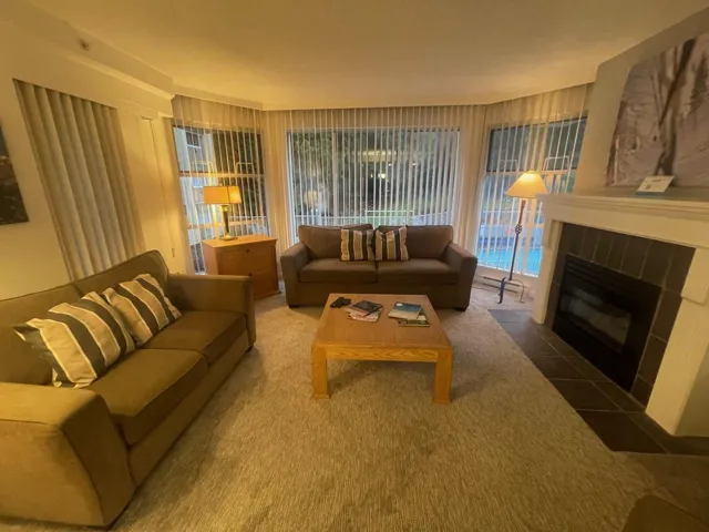 Living room with a tiled fireplace and carpet floors