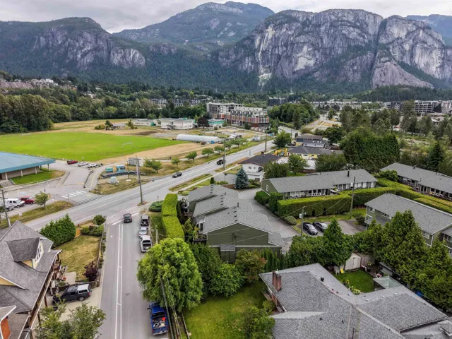 Aerial perspective showcasing a residential area with prominent mountainous backdrop