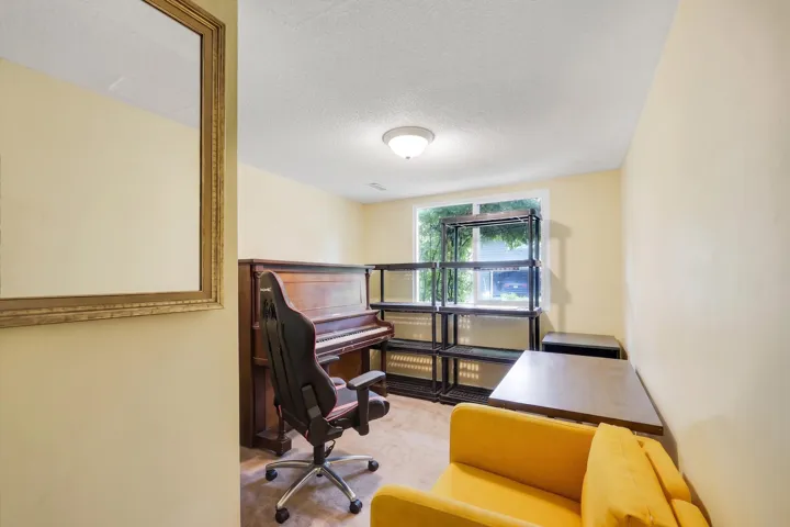 Room with light yellow walls, a window, and a flush mount ceiling light fixture