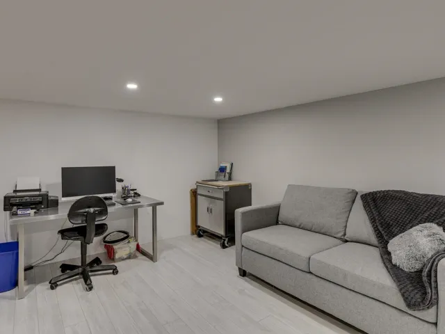 Office space featuring wood finished floors and recessed lighting