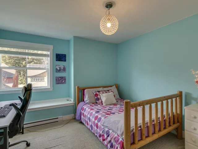 Bedroom featuring a baseboard heating unit, carpet flooring, and an office area