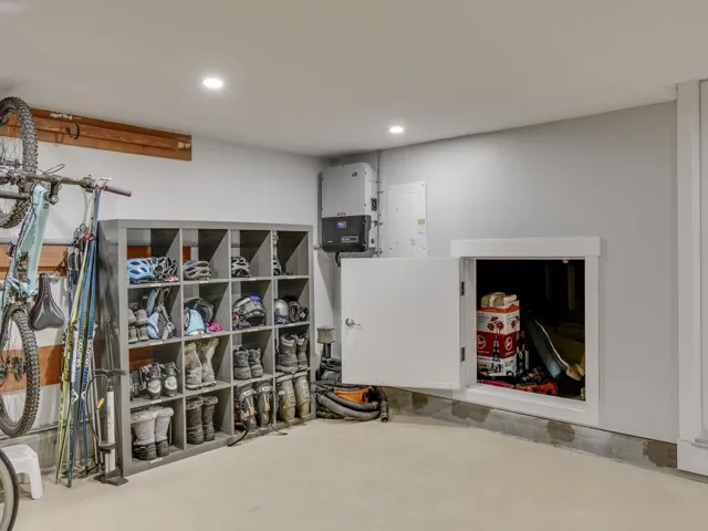 Garage featuring recessed lighting and electric panel