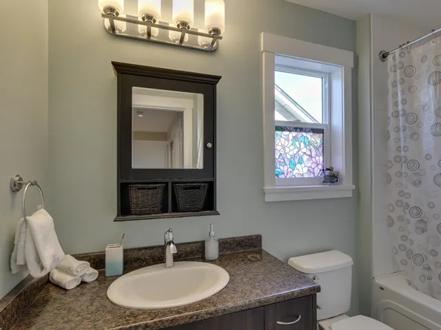 Full bath with shower / bath combination with curtain and vanity