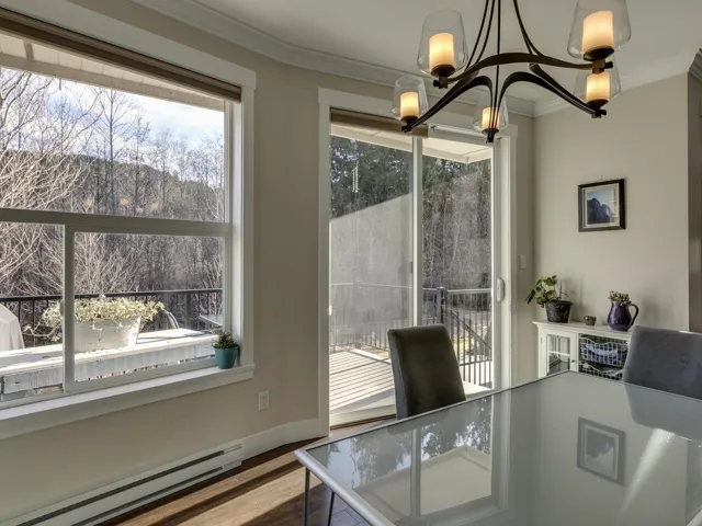 Office area with a baseboard radiator, crown molding, a chandelier, and wood finished floors