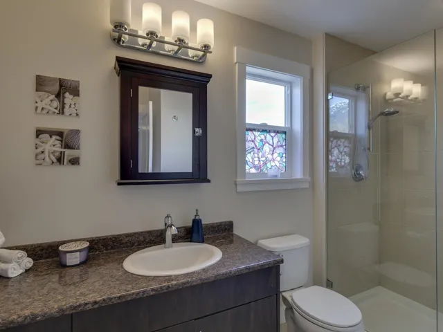 Bathroom featuring vanity and a shower stall