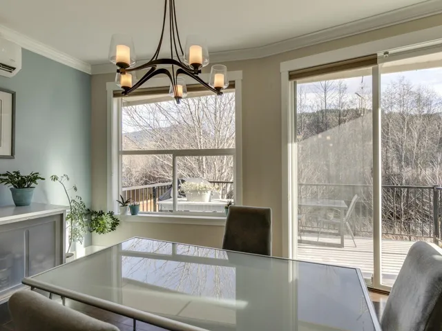 Dining space featuring ornamental molding, plenty of natural light, and an AC wall unit
