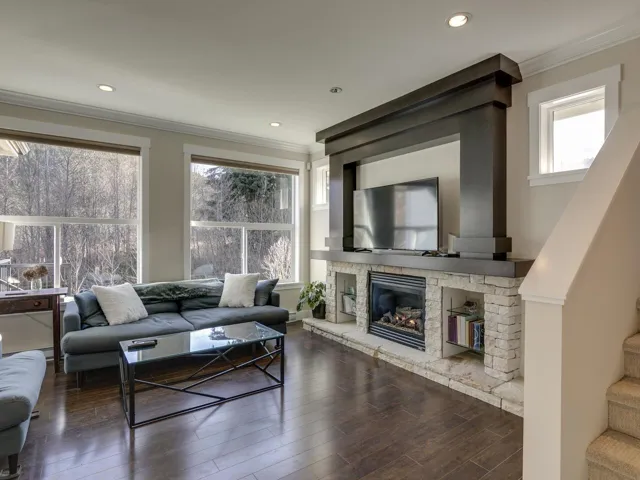 Living area with wood finished floors, ornamental molding, recessed lighting, stairs, and plenty of natural light
