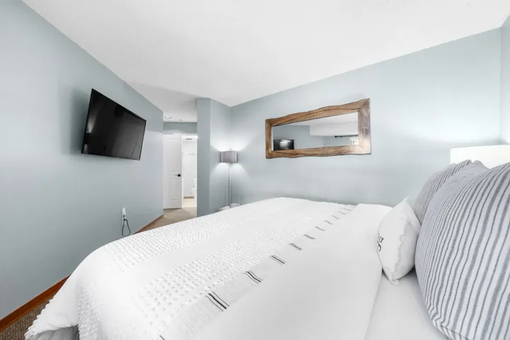 Wall-mounted television with a light blue wall finish