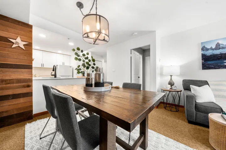 Open concept living space featuring a wood-finish accent wall