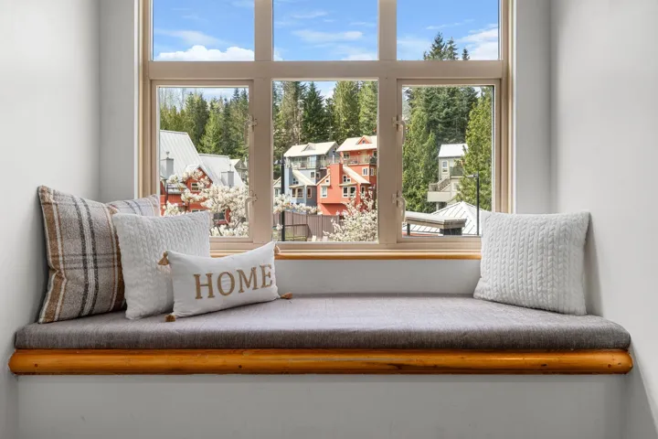 Built-in window bench featuring a natural wood frame and a soft-cushioned seat