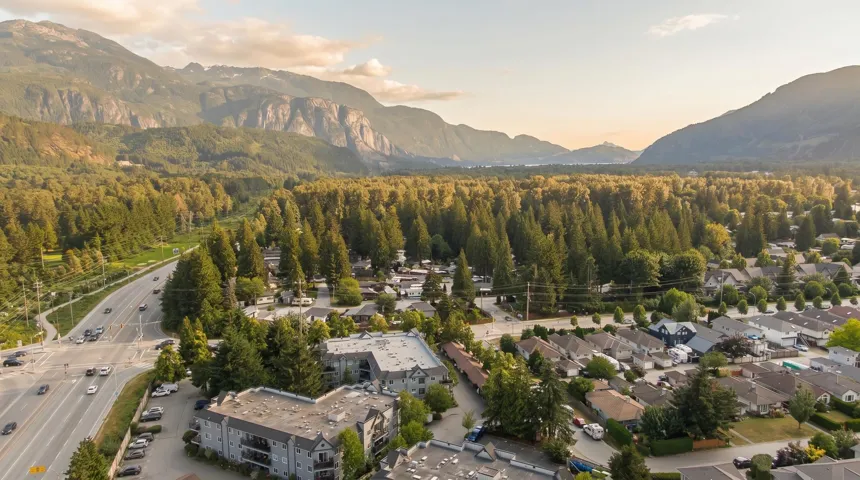 Expansive aerial showcasing a residential neighborhood against a mountainous backdrop
