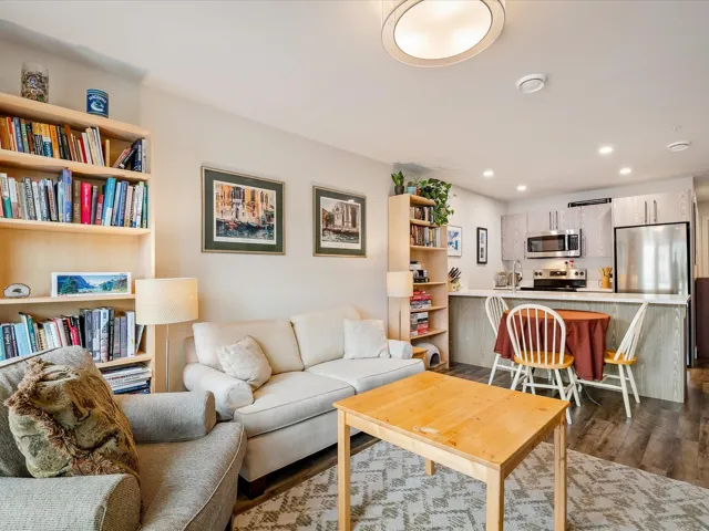 Living area with dark wood-style floors and recessed lighting