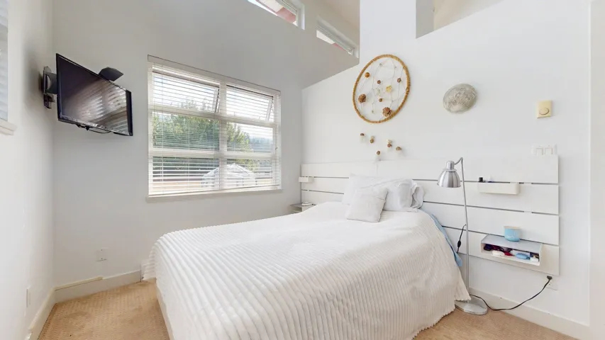 Bedroom featuring baseboards and carpet