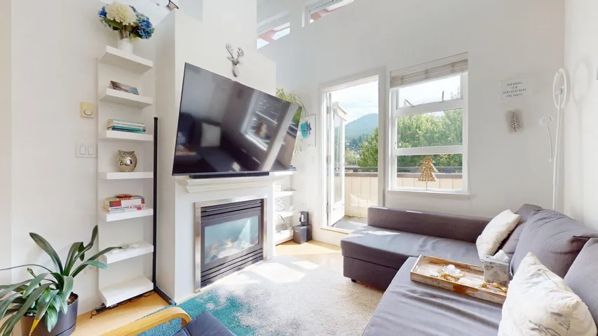 Living area featuring a glass covered fireplace and wood finished floors