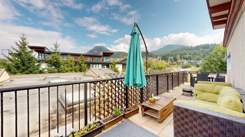 Balcony with a mountain view and an outdoor living space with a fire pit