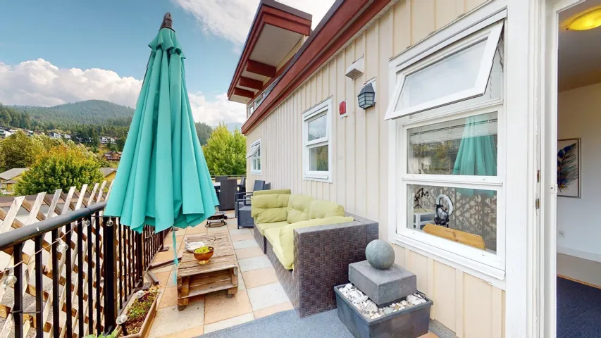 Wooden deck with outdoor lounge area, a mountain view, and a patio