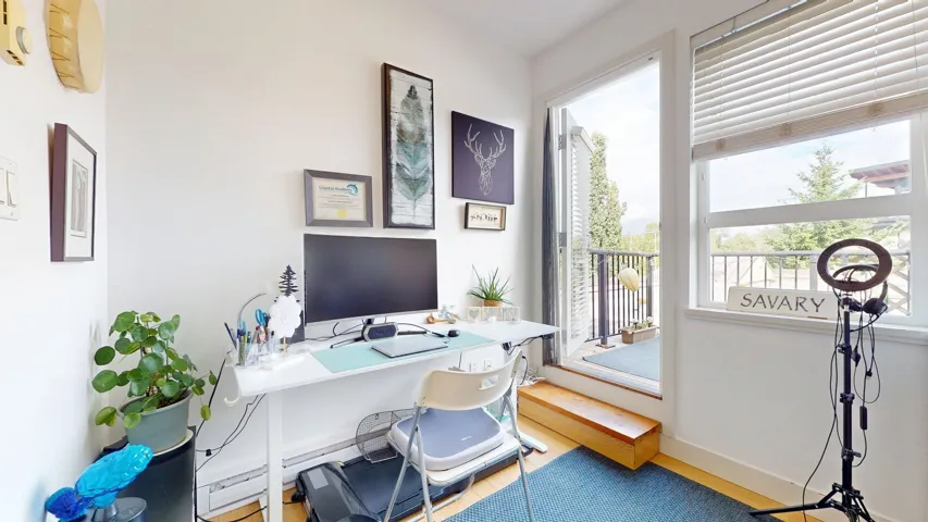 Office area with a baseboard heating unit and wood finished floors