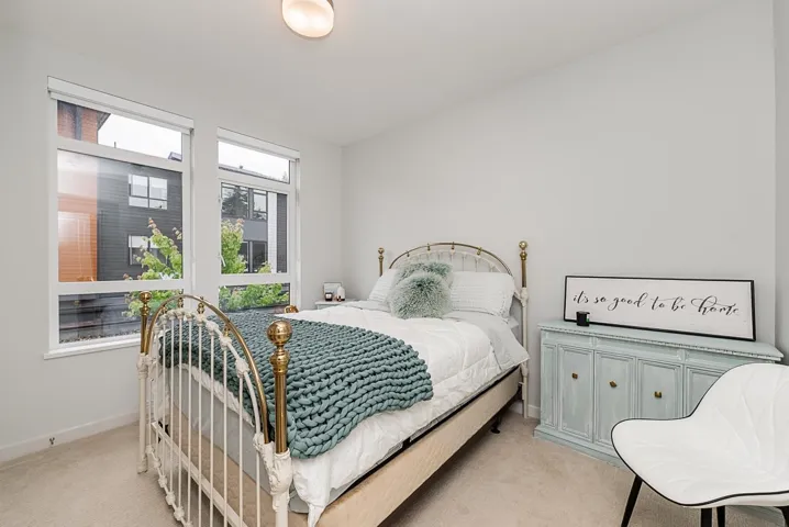 Bedroom with light carpet and baseboards