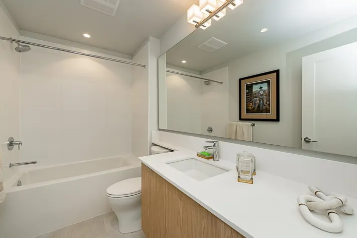 Bathroom featuring toilet, vanity, tile patterned floors, shower / bathtub combination, and recessed lighting