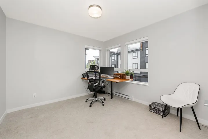 Office area with carpet floors, a baseboard heating unit, and baseboards