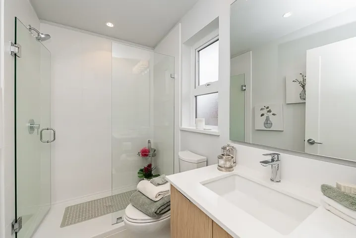 Full bath with toilet, vanity, a shower stall, and recessed lighting