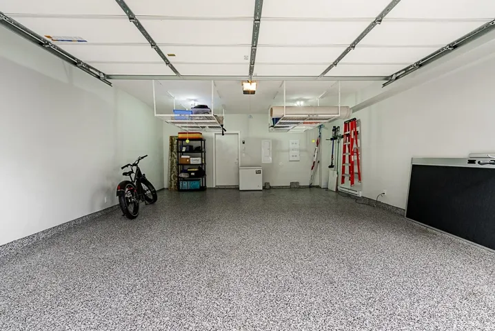 Garage with a garage door opener and refrigerator