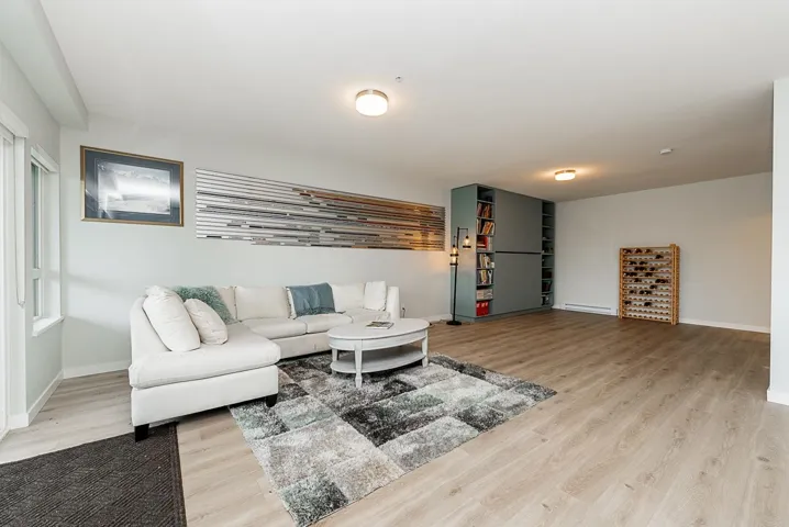 Living area featuring wood finished floors, baseboards, and baseboard heating