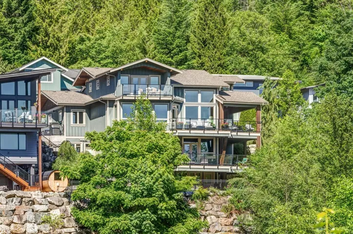 Multi-level contemporary exterior with multiple balconies featuring glass railings