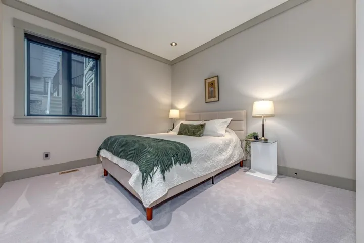 Plush light-toned carpeting extends throughout the room, complemented by neutral wall paint and matching trim