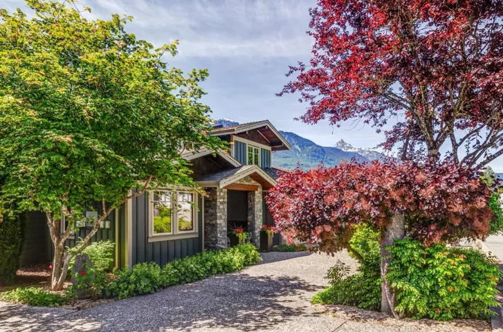 Craftsman-style home featuring stone accents and dark siding