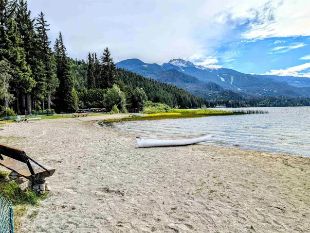 Water view featuring a mountainous background and a heavily wooded area