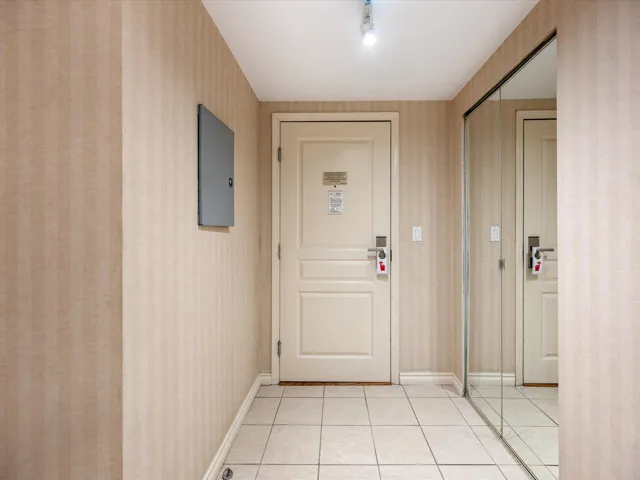 Entryway with tile patterned flooring, wallpapered walls, and electric panel