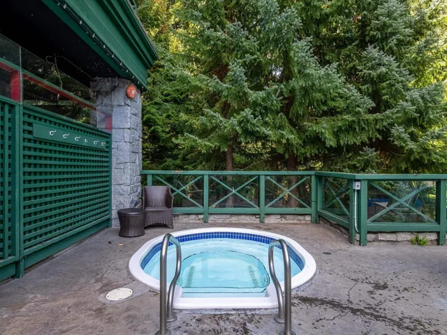 View of pool with a hot tub