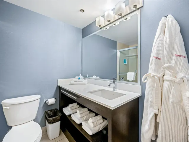 Bathroom with vanity, a shower stall, and light tile patterned floors